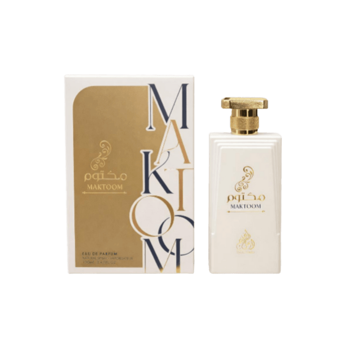 This image shows the perfume "Maktoom," housed in an elegant, white bottle with gold accents. The packaging features a sophisticated design with a modern touch.