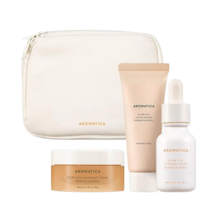 Aromatica skincare set with zip pouch, cream jar, facial cleanser tube, and serum dropper bottle.