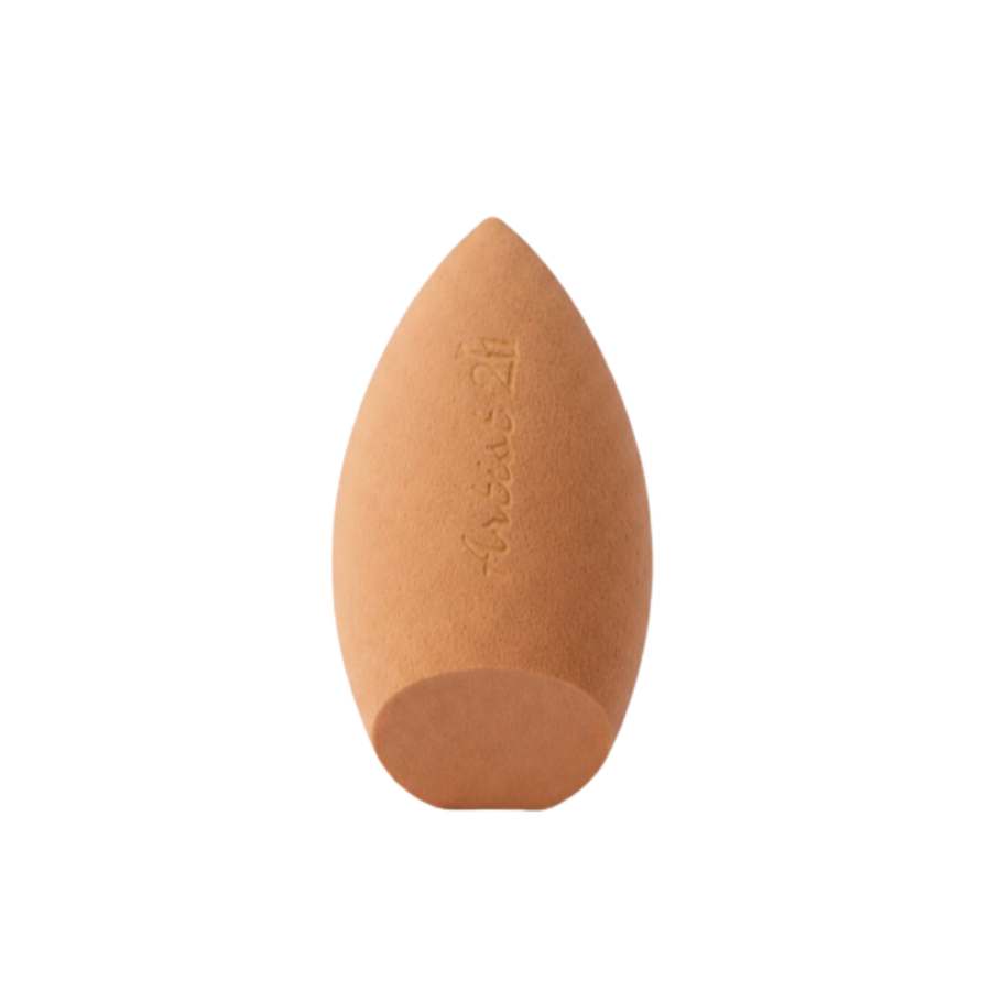 Teardrop-shaped makeup blending sponge in nude shade for foundation and concealer application.