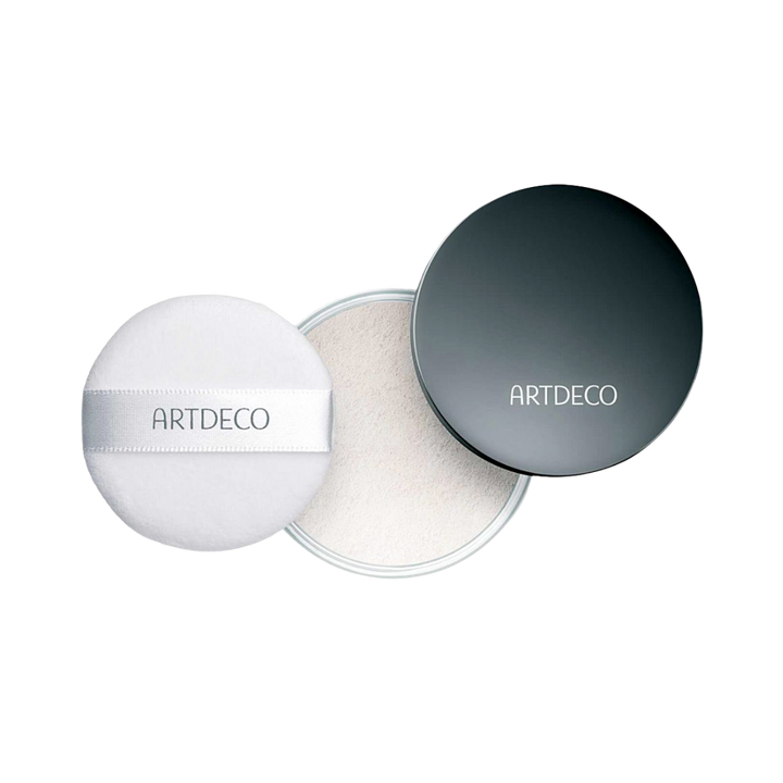 Artdeco translucent loose powder in a black container with a white puff.