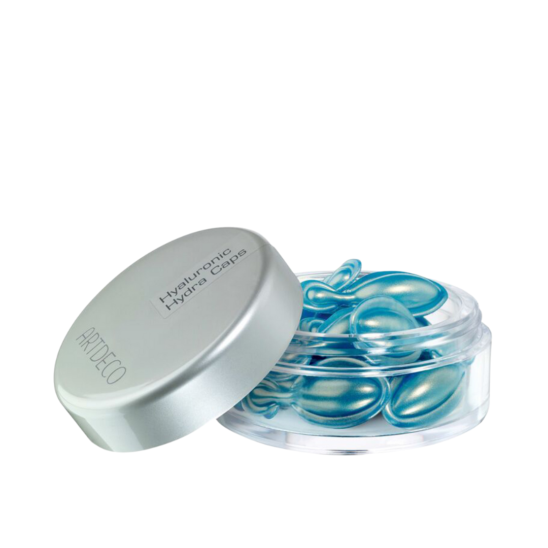 Artdeco Hyaluronic Hydra Caps in a clear jar with a silver lid, containing small blue capsules.