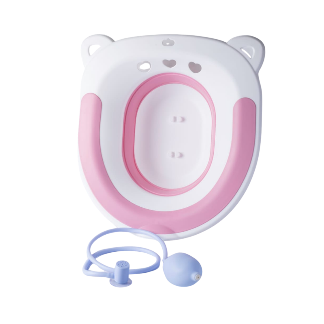 Pink and white children toilet training seat with water cleaning tube and squeeze bulb attachment