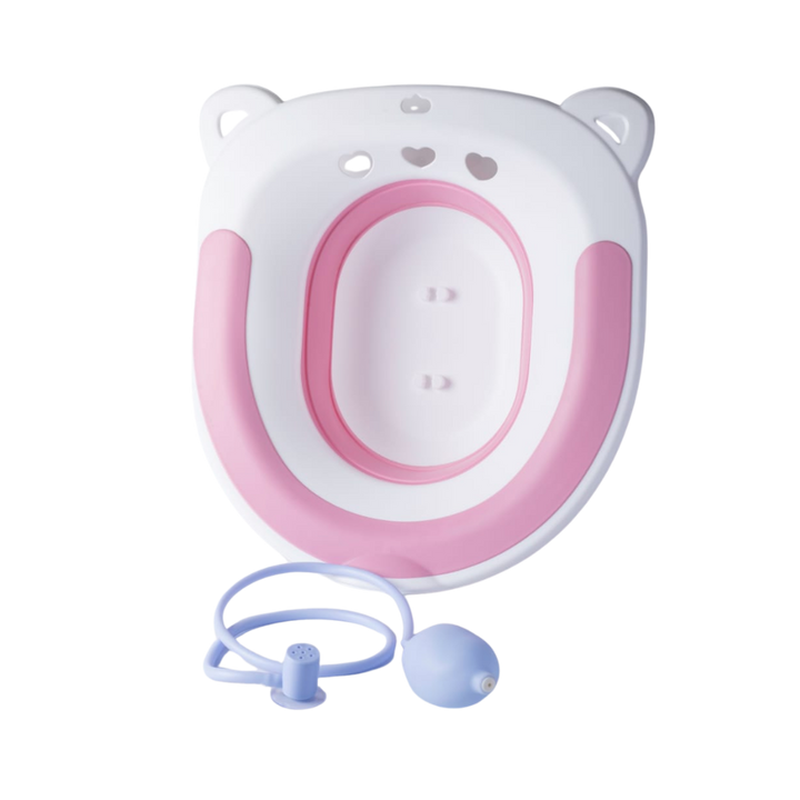 Pink and white children toilet training seat with water cleaning tube and squeeze bulb attachment