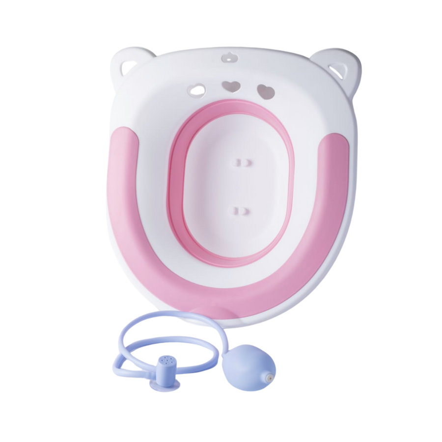 Pink and white children toilet training seat with water cleaning tube and squeeze bulb attachment