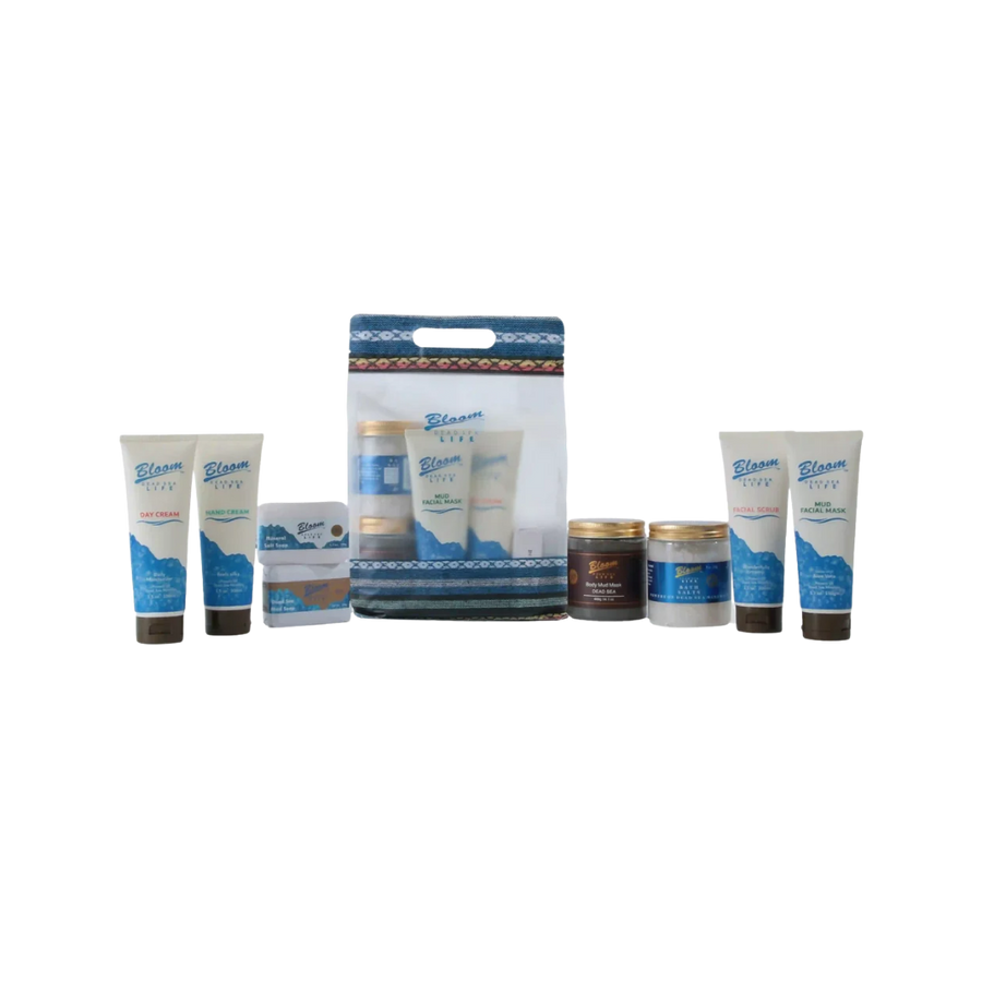 Bloom Dead Sea Life skincare set with creams, scrubs, masks, jars, and patterned carry bag.