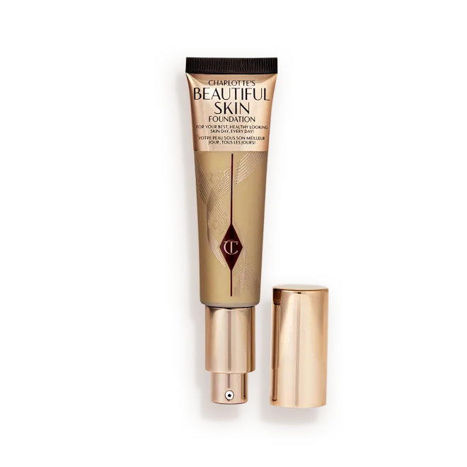 Charlotte Tilbury Beautiful Skin Foundation, beige tube with rose-gold pump, cap, and geometric logo detailing.