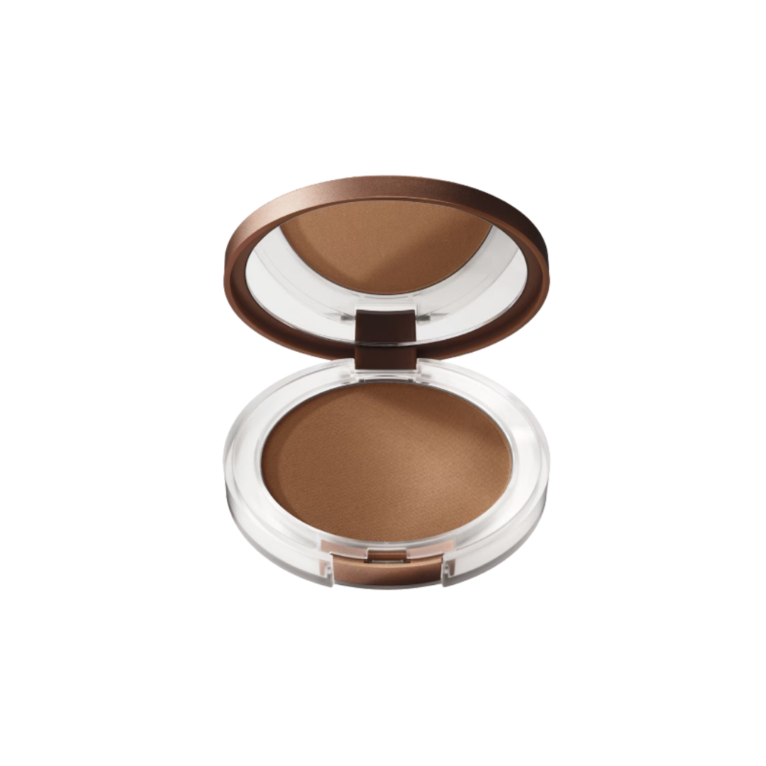 Open compact bronzing powder in clear case with brown lid and mirror, warm tan shade