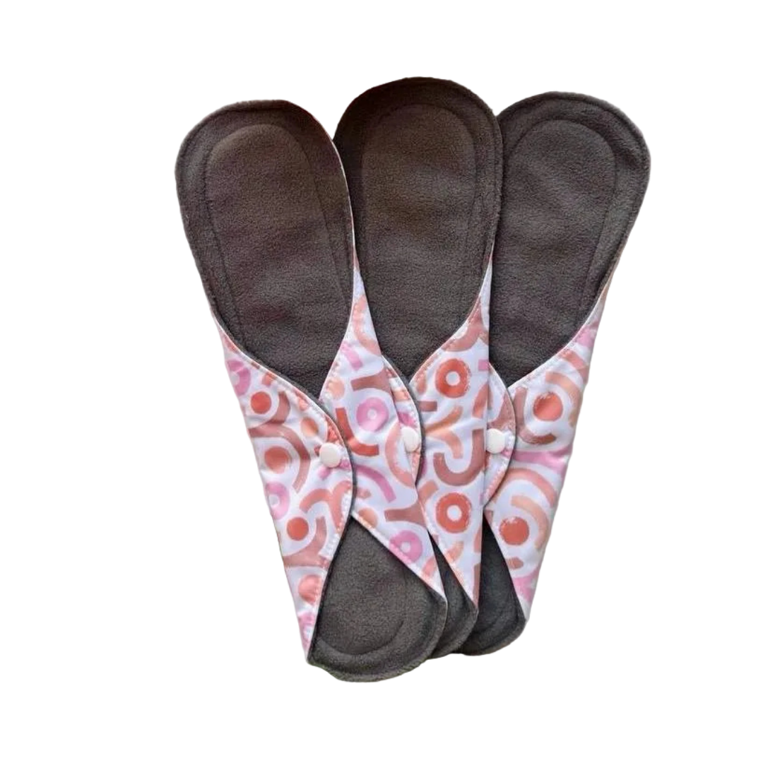 DAWRATY reusable menstrual pads, size L, three dark gray pads with pink patterned wings and snap buttons