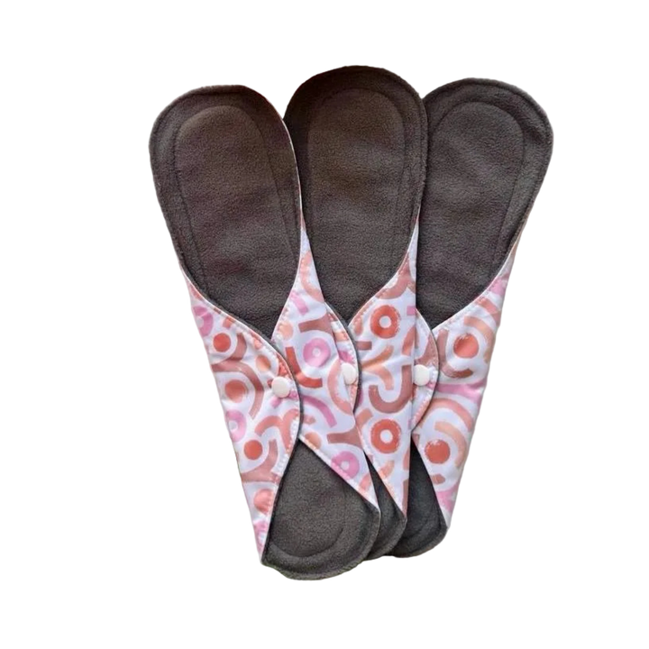 DAWRATY reusable menstrual pads, size L, three dark gray pads with pink patterned wings and snap buttons
