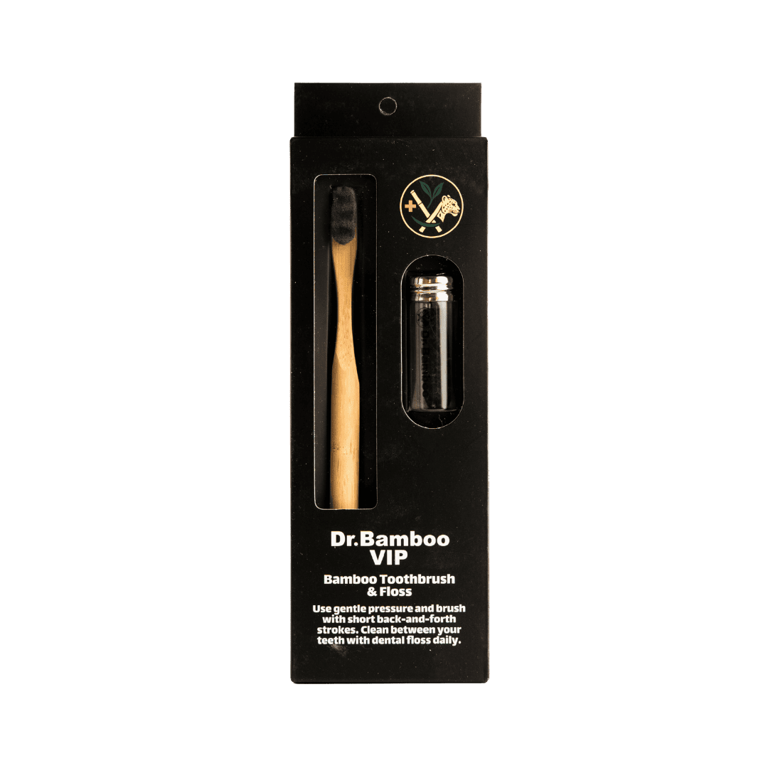 "Dr. Bamboo VIP Bamboo Toothbrush & Dental Floss, packaged in a black box with a bamboo toothbrush and floss inside."