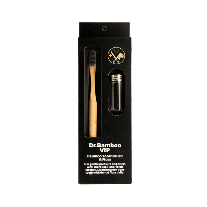 "Dr. Bamboo VIP Bamboo Toothbrush & Dental Floss, packaged in a black box with a bamboo toothbrush and floss inside."