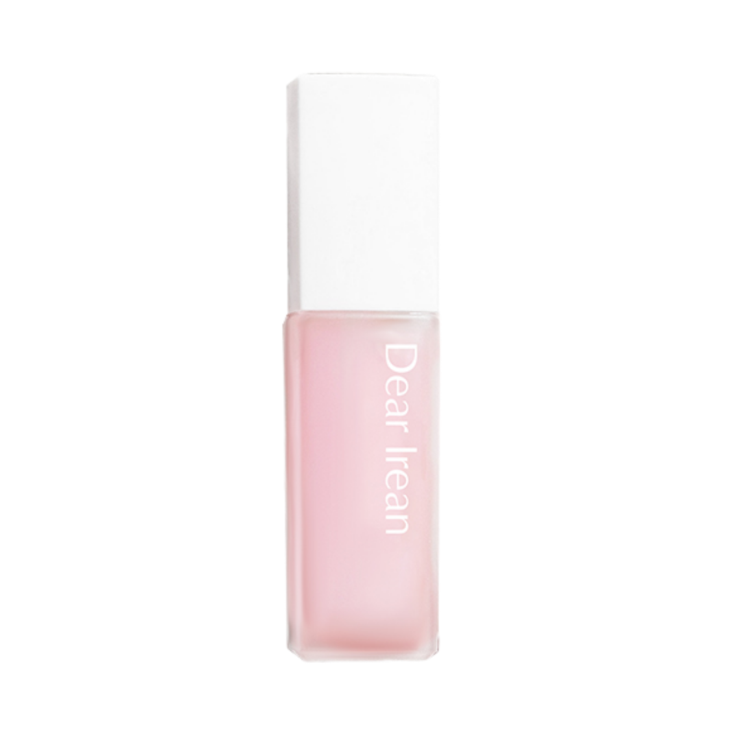 Dearreian fragrance oil, pink liquid in a square glass bottle with a white cap and minimalist label.
