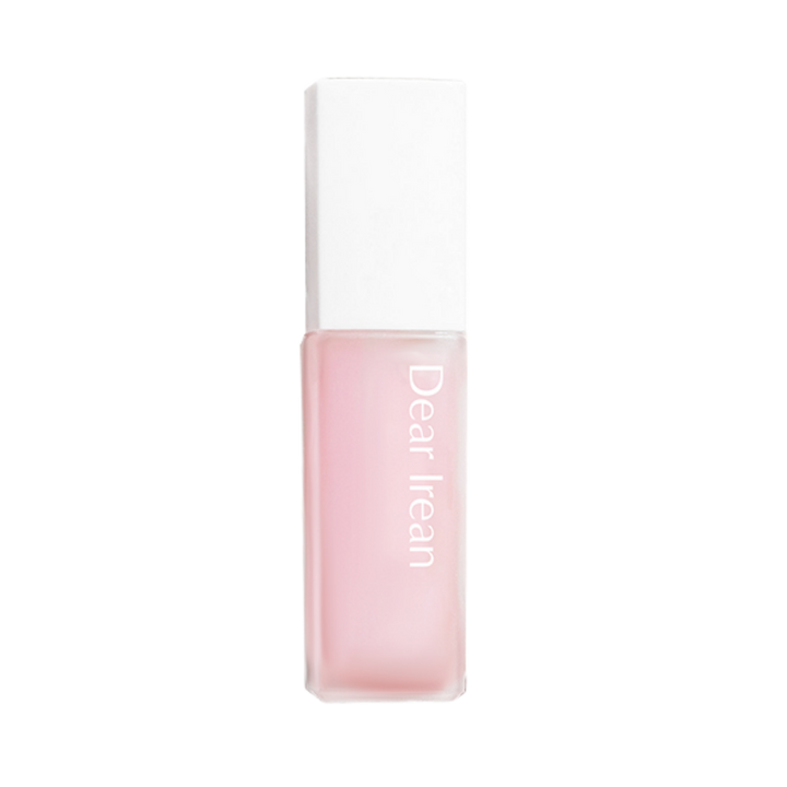 Dearreian fragrance oil, pink liquid in a square glass bottle with a white cap and minimalist label.
