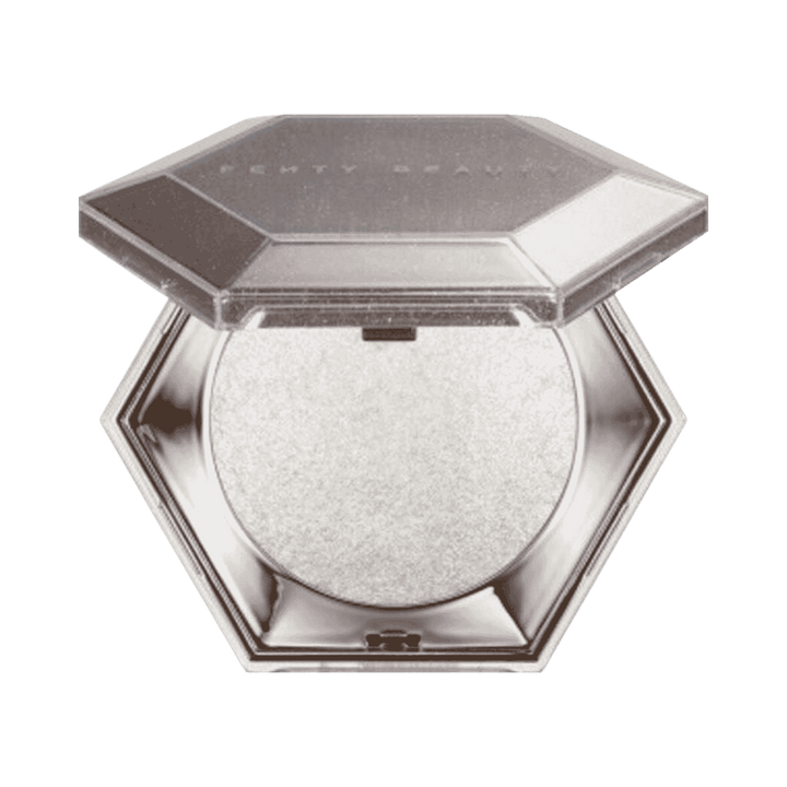 Fenty Beauty Diamond Bomb highlighter in silver hexagonal compact with open lid and white shimmer pan