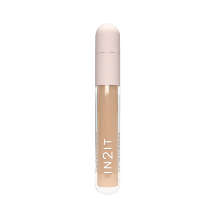 IN2IT liquid concealer tube with beige formula and rounded light pink cap packaging