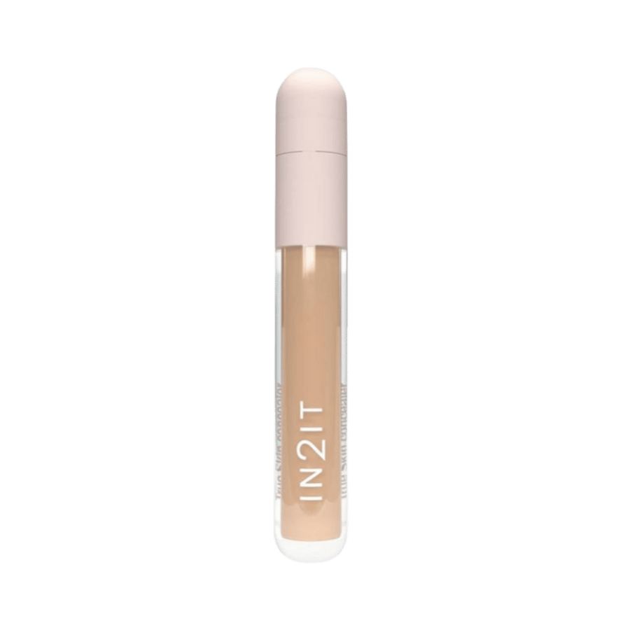 IN2IT liquid concealer tube with beige formula and rounded light pink cap packaging