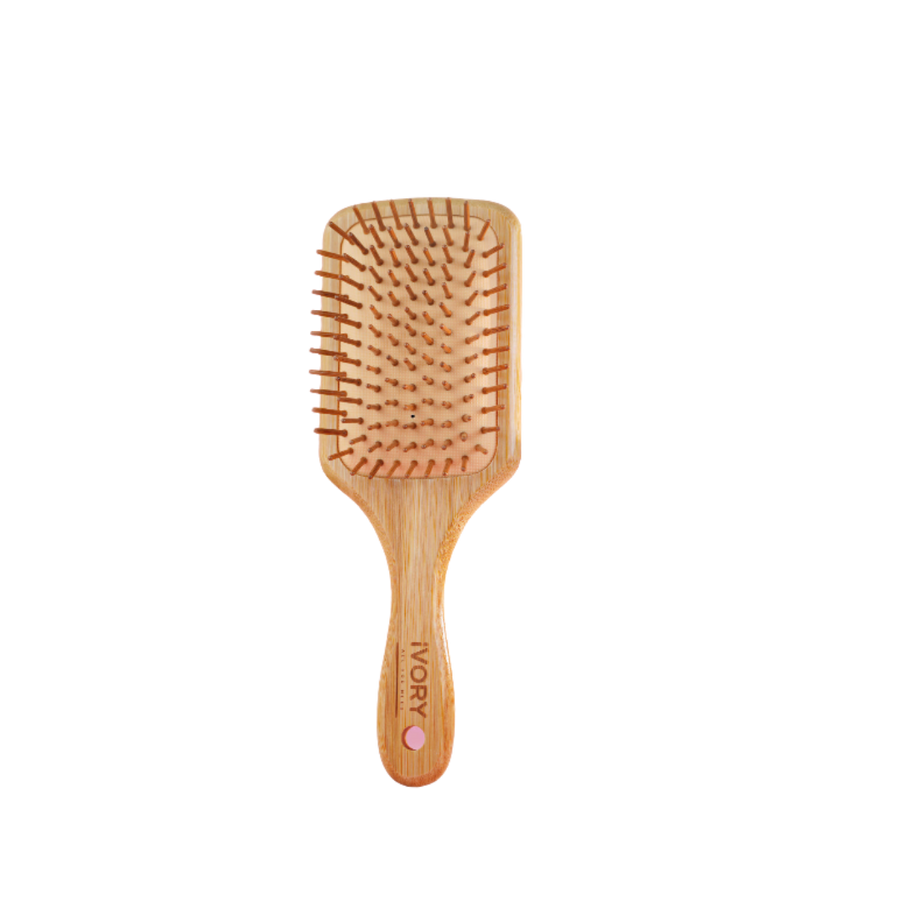 Ivory wooden hairbrush with soft pins, designed for detangling and smoothing hair.