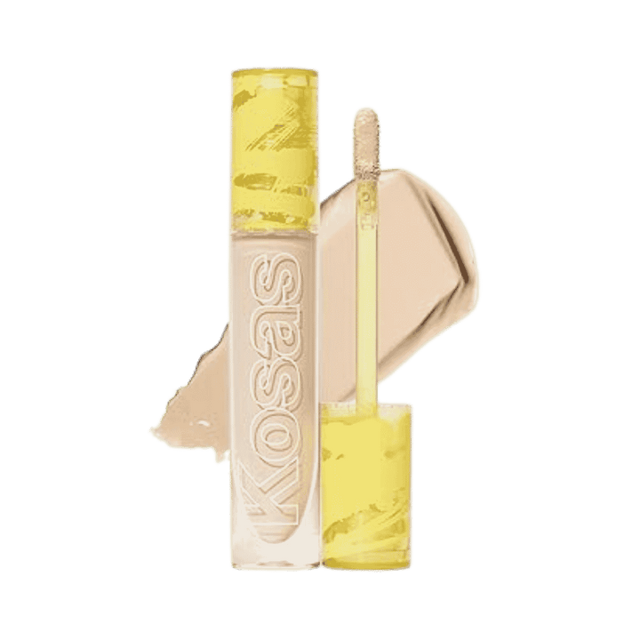Kosas concealer in clear tube with yellow cap, doe-foot applicator, and beige product swatch.