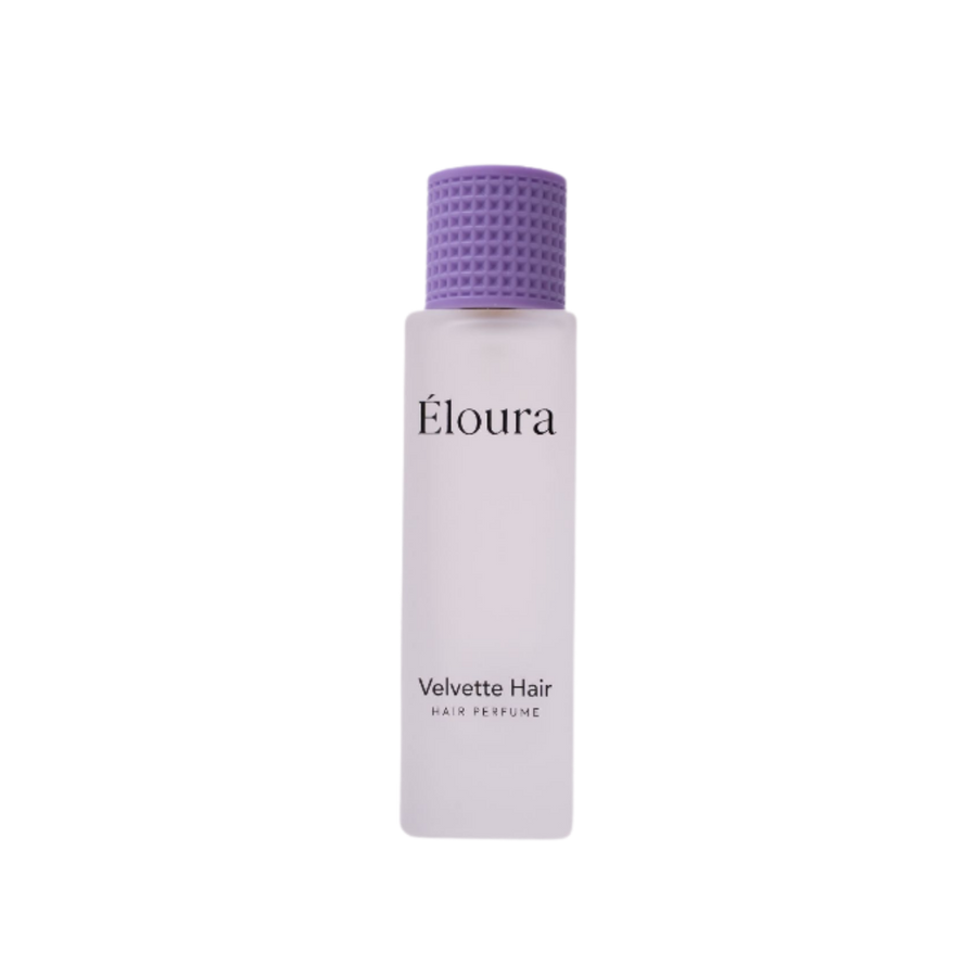 Éloura Velvette Hair Perfume in a frosted white bottle with a textured purple cap.