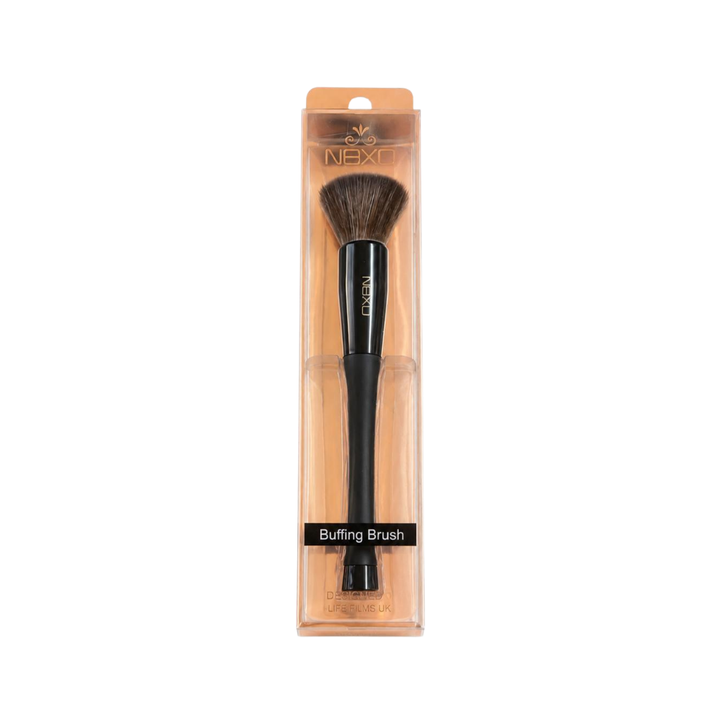 NEXO buffing brush with dense brown bristles, black handle, and transparent peach-colored retail packaging.