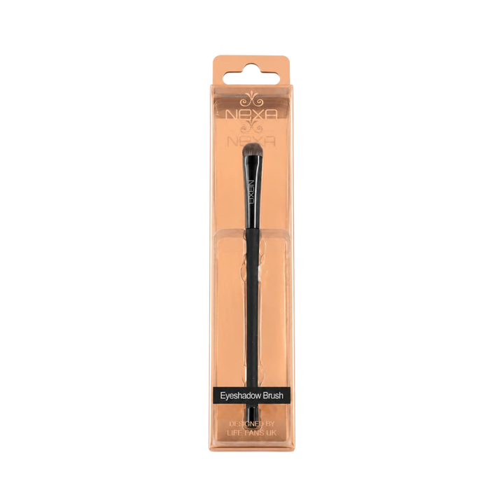 NEXA eyeshadow brush with black handle, rounded gray bristles, and transparent peach-colored retail packaging.