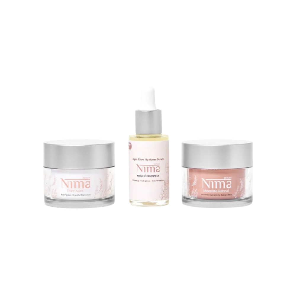 Nima skincare set with hyaluronic serum dropper and two face creams, glass jars and bottle packaging.