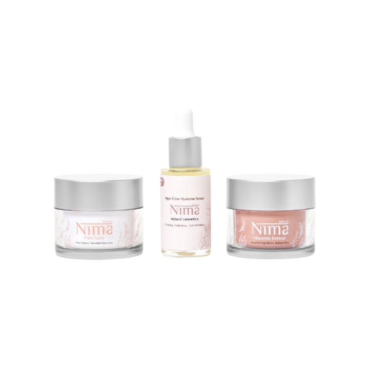 Nima skincare set with hyaluronic serum dropper and two face creams, glass jars and bottle packaging.