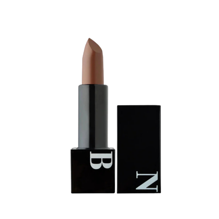 Black lipstick with nude beige bullet, square black tube, white “B” logo, removable black cap with “N”.