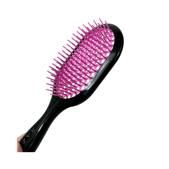 RAZZO hair brush with black handle, pink vented cushion, and flexible plastic bristles for detangling