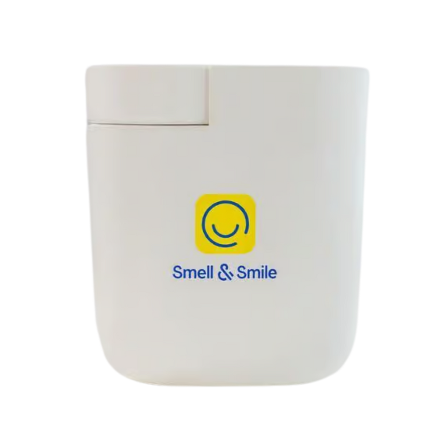 Smell & Smile fragrance device, white rectangular plastic diffuser with flip-top lid, printed logo front.
