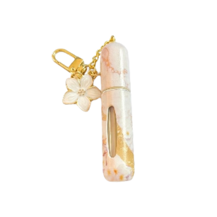 White marble-patterned refillable perfume bottle with gold flower keychain, 10 ml capacity
