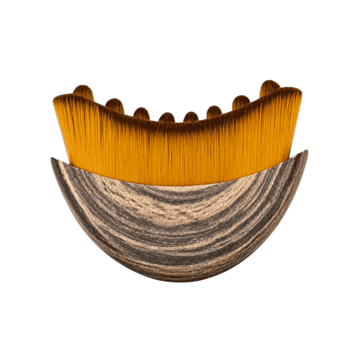 Curved makeup foundation brush with dense golden bristles and sculpted wood-grain patterned ergonomic handle.