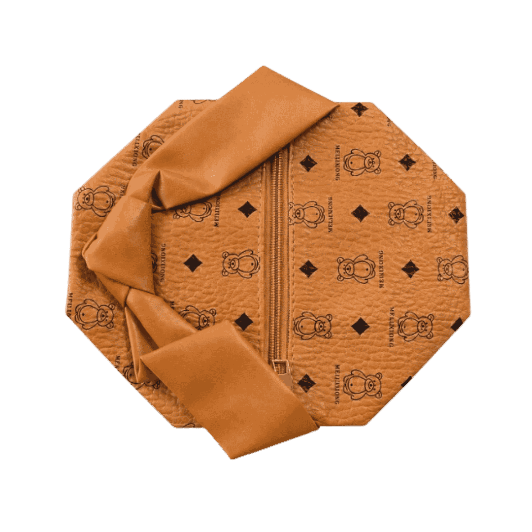 Brown leather washbag with zip closure, black printed motifs, and wide matching decorative strap.