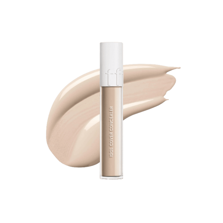 Tfit Idol Cover Concealer, frosted cylindrical tube with white cap, beige concealer swatch behind, printed text branding, 607x615px 